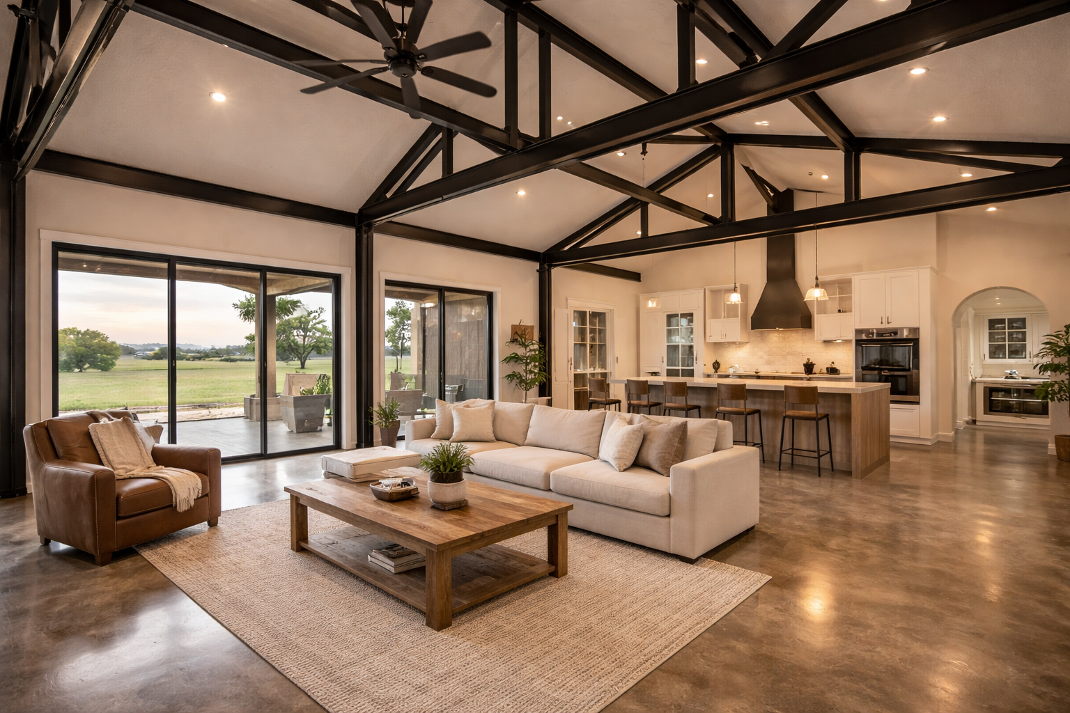 Barndominium interior with exposed steel beams and polished concrete floors.